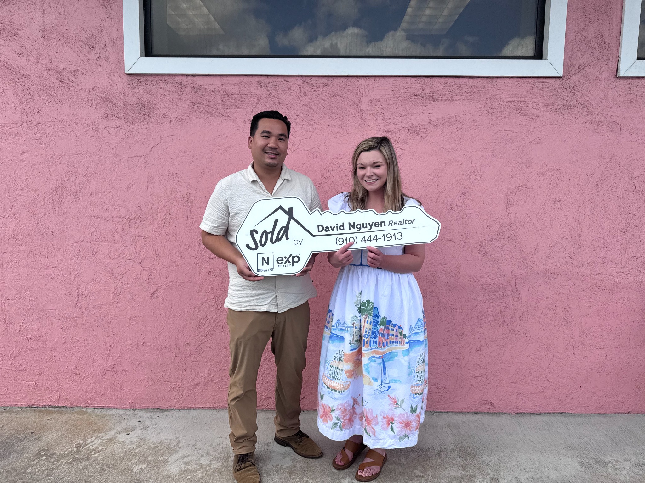 David Nguyen celebrating a sale with a client