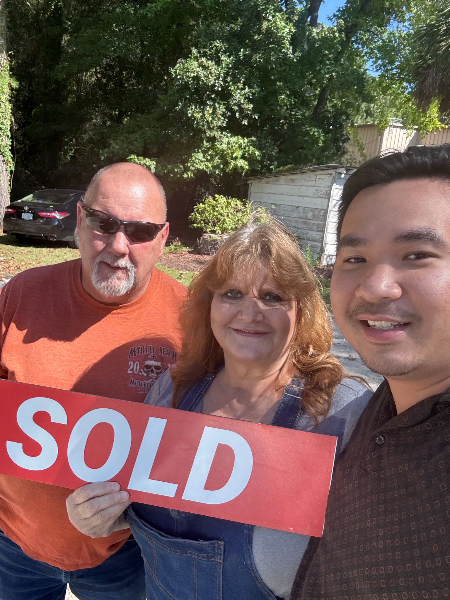 David Nguyen celebrating a sold property with clients